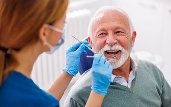 Mature man smiling during dental checkup