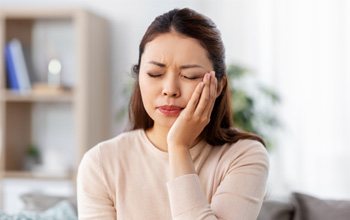 Concerned woman struggling with mouth pain