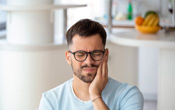 Grimacing man struggling with mouth pain