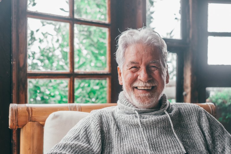 older man smiling with dental implants